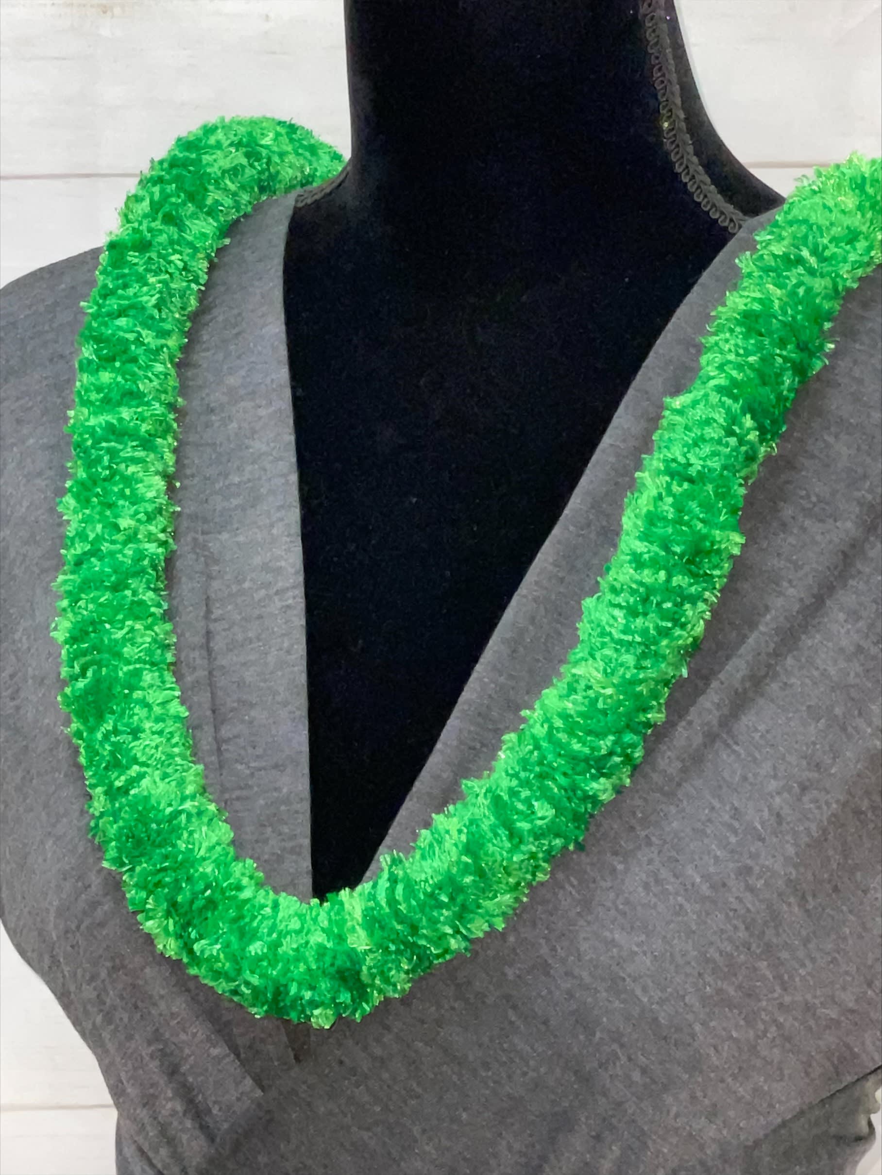 Bright green synthetic lei draped around the neck of a mannequin in a gray top