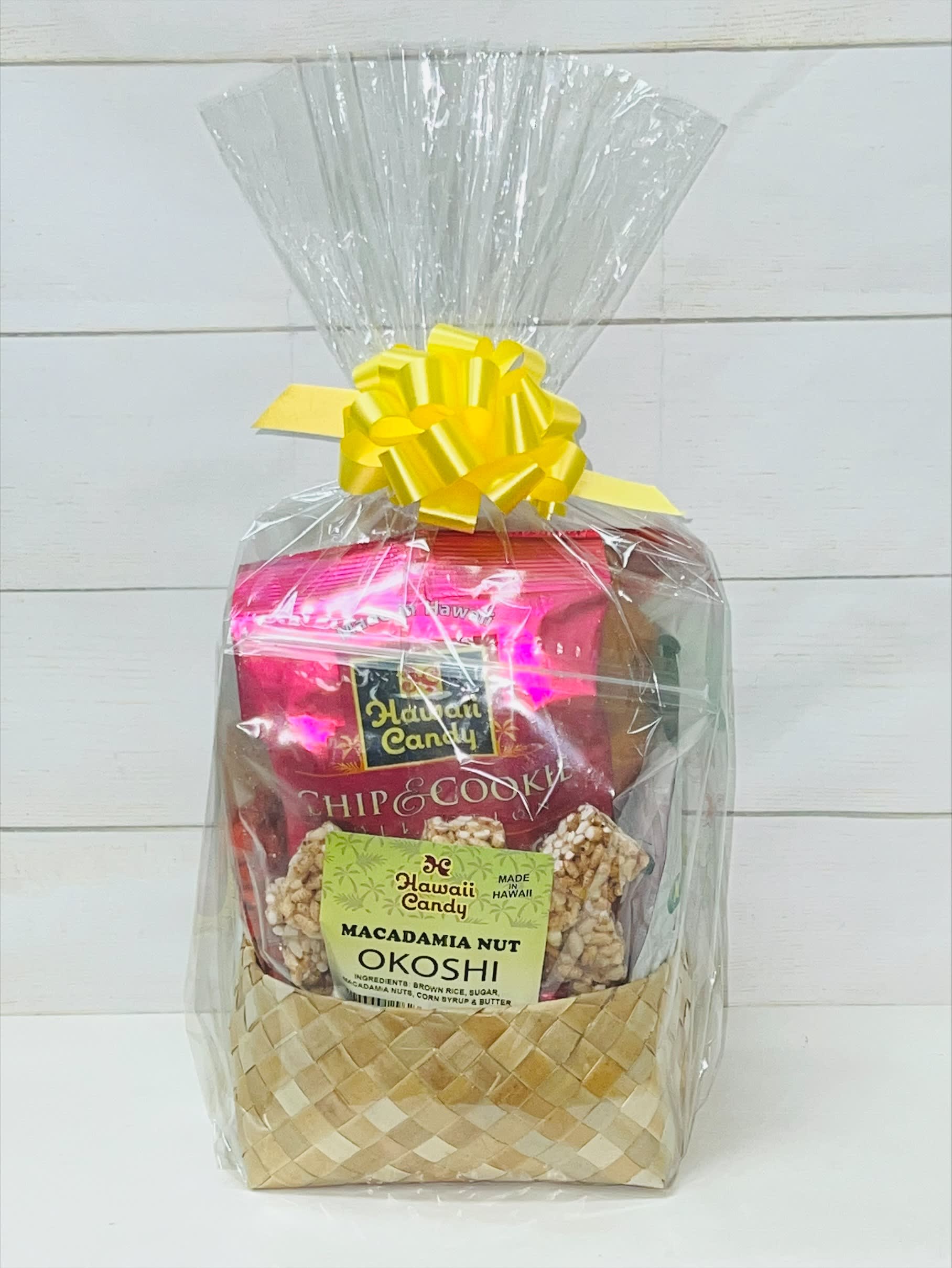 Gift basket of Hawaiian snacks wrapped in clear cellophane with a yellow bow
