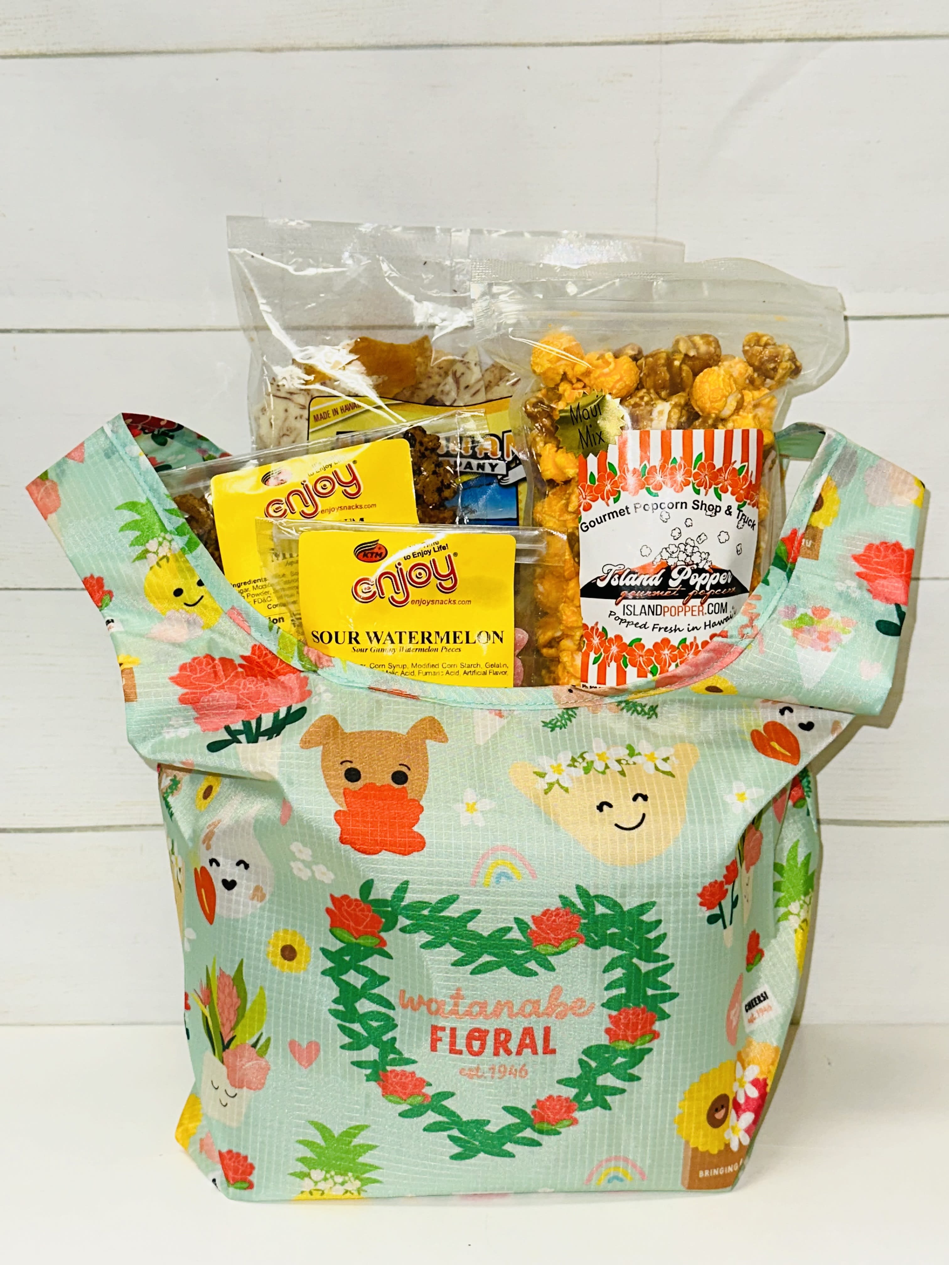 Gift tote filled with assorted packaged snacks and popcorn