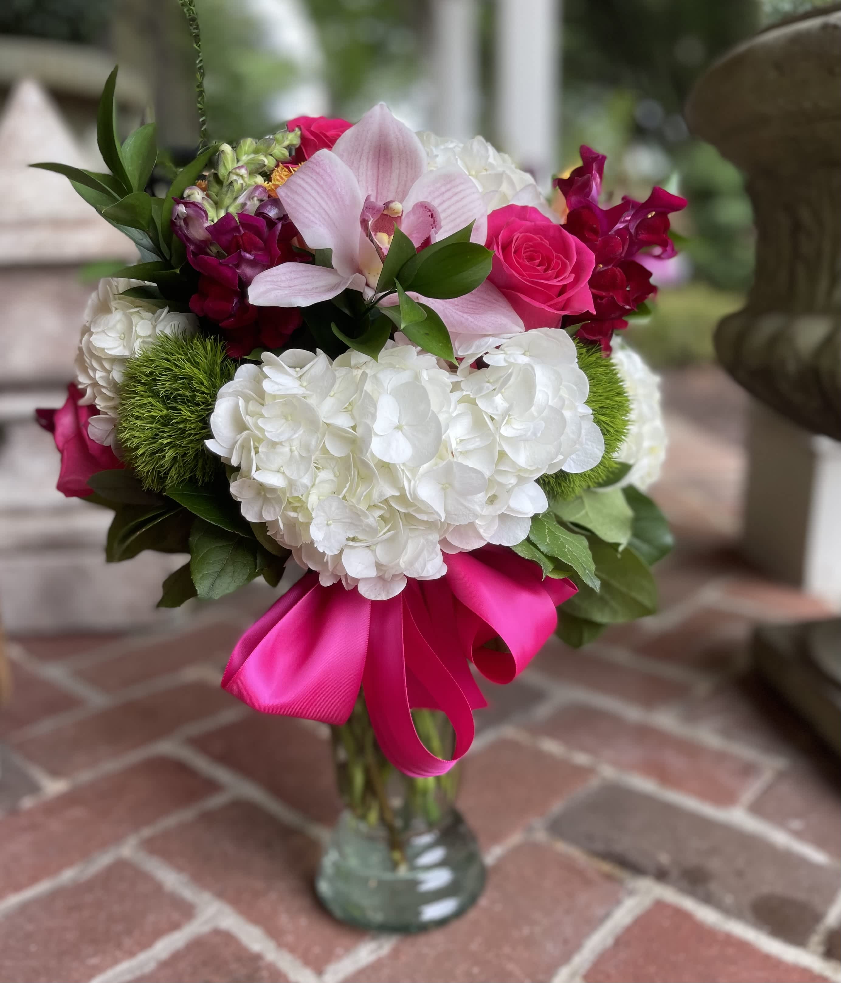 Strawberry Fields - Strawberry Fields Arrangement  Looking for a stunning floral arrangement in Wilmington, Delaware? Look no further than Strawberry Fields. This beautiful bouquet includes white hydrangea, green dianthus, pink roses, burgundy snapdragon, and pink orchids, all arranged in a tall glass vase and finished with a dark pink ribbon.  Whether you're celebrating a special occasion or just want to brighten someone's day, Strawberry Fields is the perfect choice. With convenient delivery to Wilmington, Delaware and surrounding areas, it's never been easier to send a beautiful bouquet to someone you care about. Order now and let Strawberry Fields bring a smile to someone's face! Tax free, same day hand delivery,.