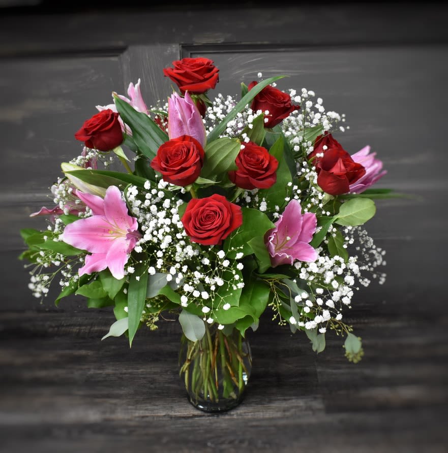 Premium Roses &amp; Lilies - One of our most popular bouquets of all time! This vase has one dozen long stem roses and 6 stems of fragrant pink Oriental lilies accented with foliages and Babies Breath. 