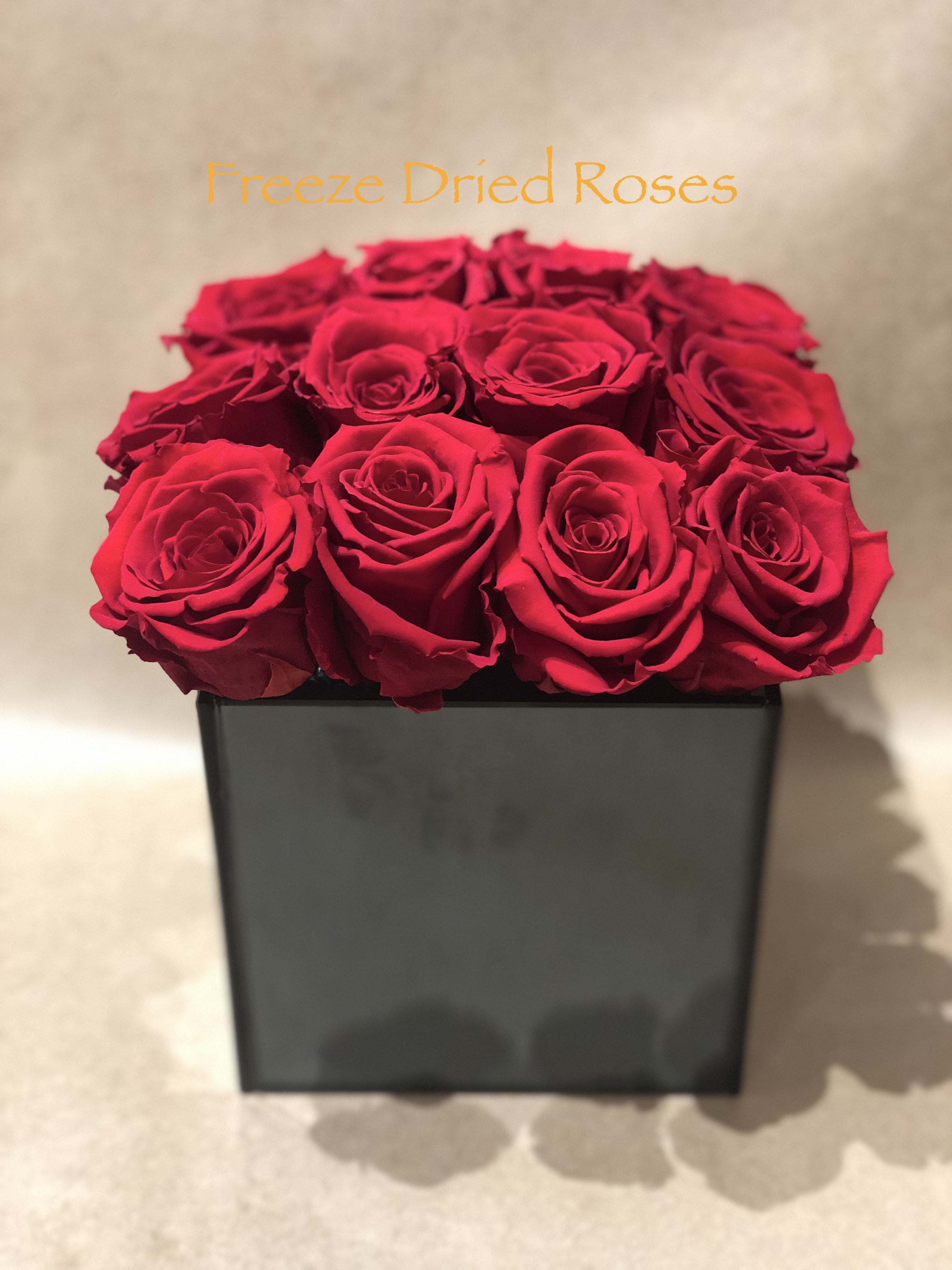 Box of red roses in a black square container