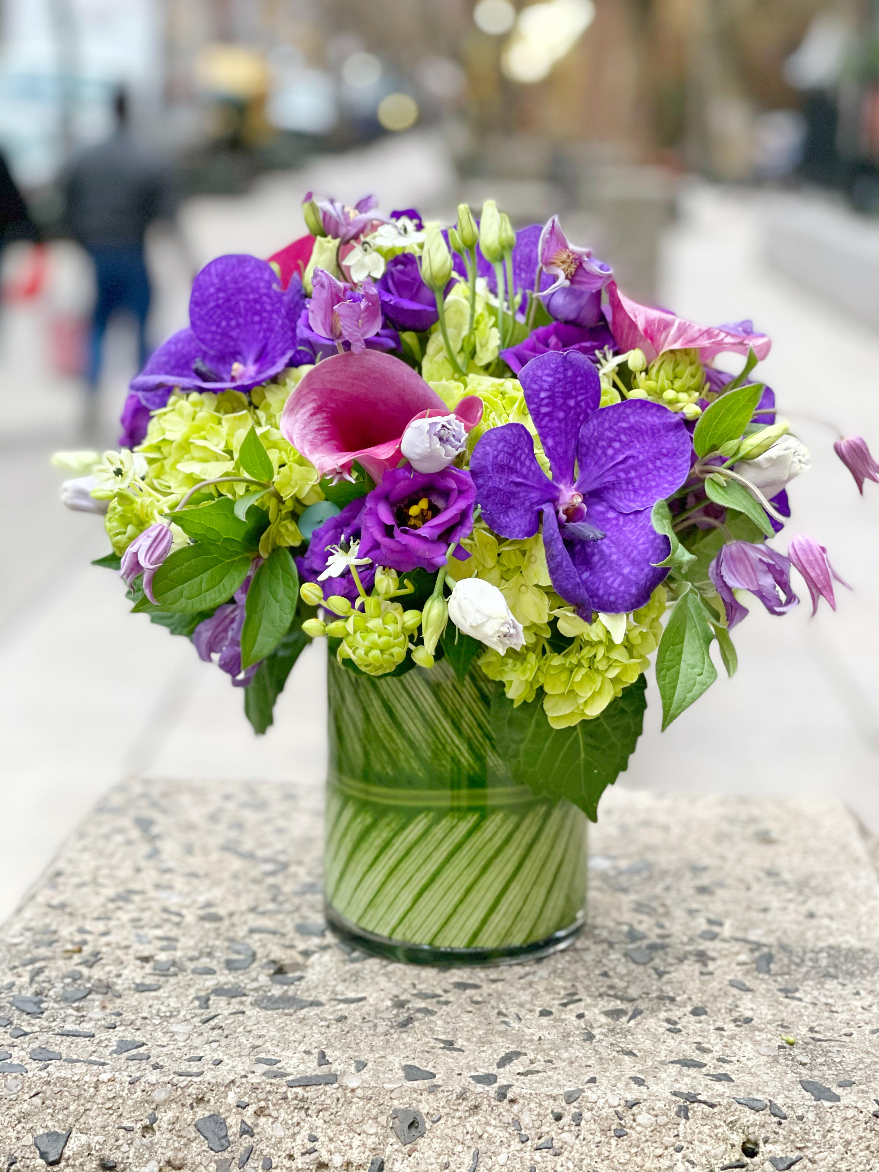 Purple and pink mixed bouquet in a glass vase