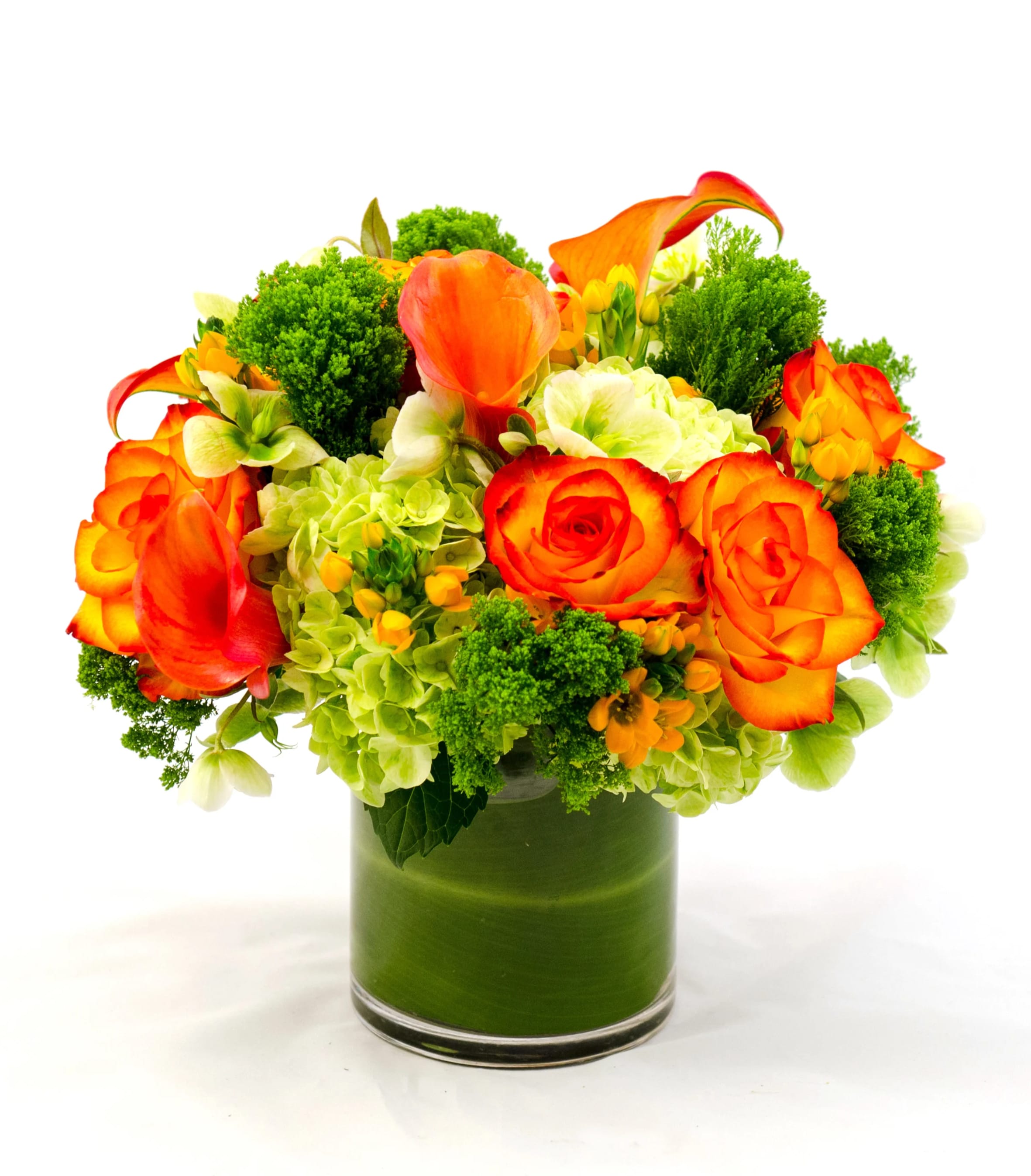 Orange roses and calla lilies in a green glass vase