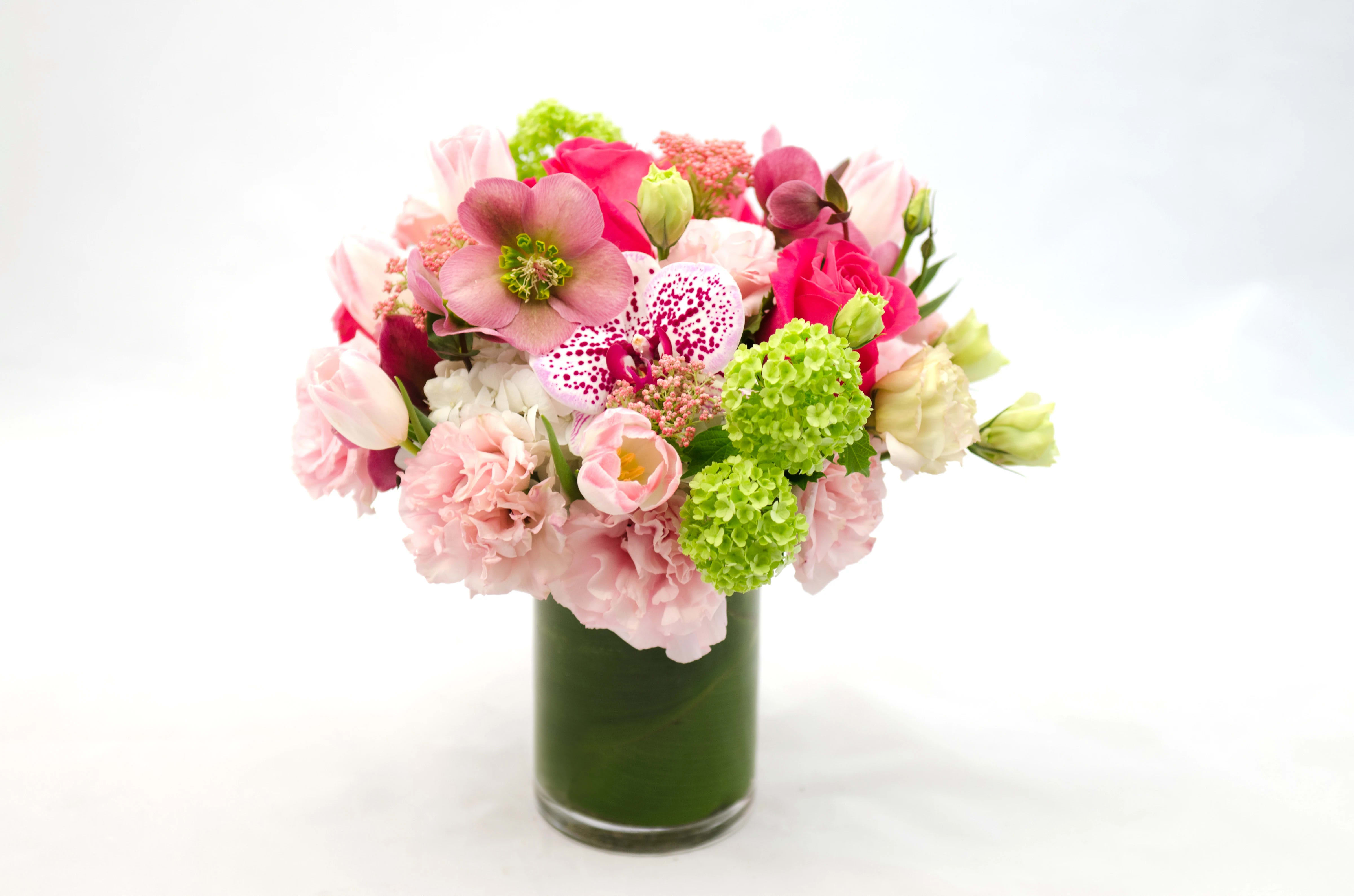 Pink and white mixed bouquet in a tall glass vase