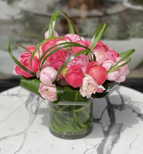 Pink ranunculus bouquet in a clear glass vase
