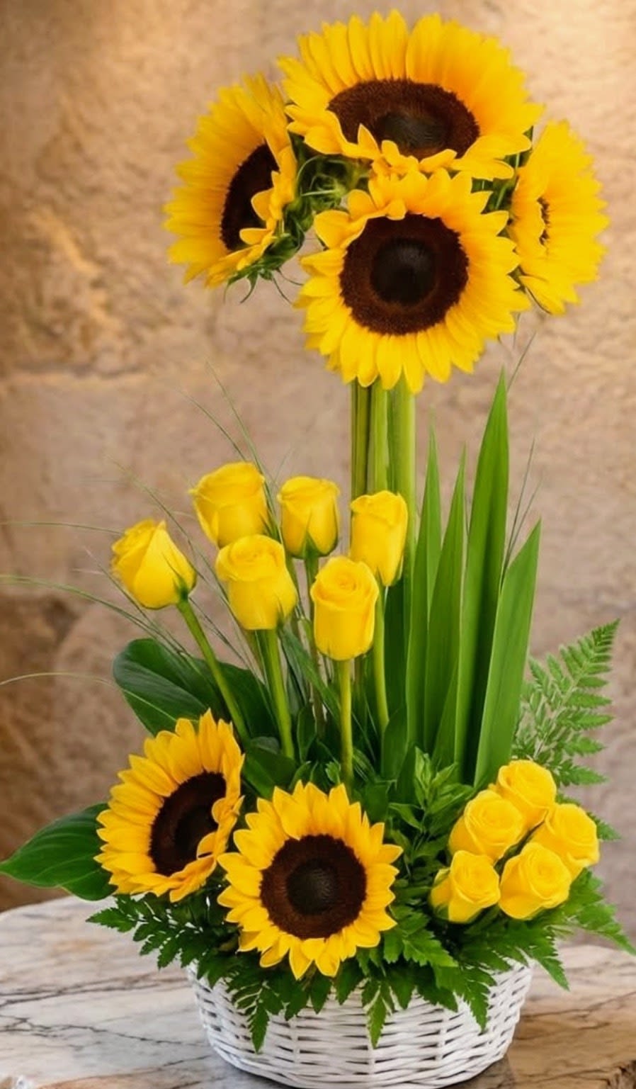Sunflower &amp; Yellow Roses Basket – Same Day Delivery San Antonio - Bright sunflower and yellow rose arrangement in San Antonio by Snyder Flowers featuring fresh sunflowers, yellow roses, seasonal greenery and tropical leaves designed in a beautiful basket perfect for Mother’s Day, birthdays, congratulations and happy occasions with same day flower delivery in San Antonio, premium quality fresh flowers and affordable prices that make every gift special and full of joy