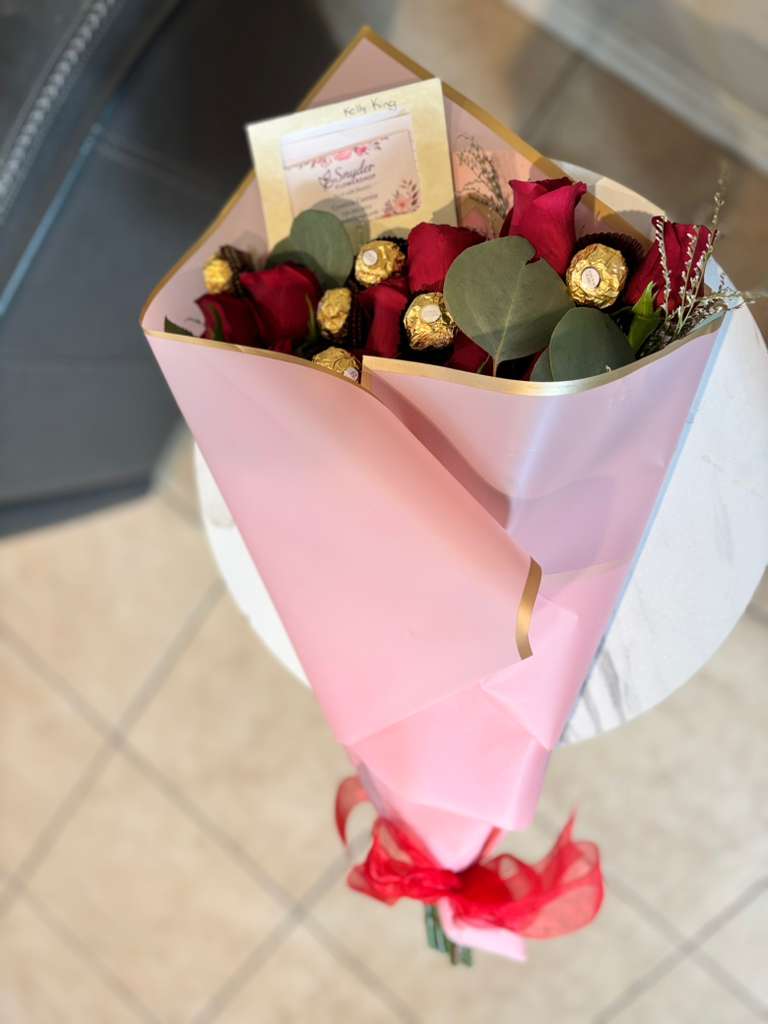 Luxury Romance Rose Bouquet - Luxury red rose bouquet handcrafted with fresh premium roses, Ferrero Rocher chocolates and elegant modern wrapping by Snyder Flowers in San Antonio. This romantic flower bouquet is perfect for anniversaries, birthdays, Valentine’s Day, graduations, love celebrations and special occasions. Our San Antonio florist specializes in luxury flower arrangements, fresh premium roses, custom bouquets and same day flower delivery with affordable pricing and exceptional customer service. Snyder Flowers proudly creates handcrafted floral designs using fresh high quality flowers and elegant presentation for customers looking for beautiful flower delivery in San Antonio with reliable same day service and luxury floral style.