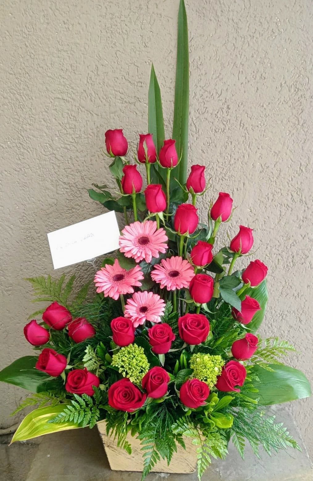 Forever Love Rose  - Elegant flower arrangement designed with premium red roses, pink gerbera daisies, fresh greenery and seasonal blooms handcrafted by Snyder Flower Shop in San Antonio TX. Perfect for anniversaries, birthdays, romantic surprises, Valentine’s Day, congratulations and special occasions with same day flower delivery in San Antonio. Our local florist creates custom flower arrangements using fresh roses, orchids, tulips, lilies and premium flowers for every celebration.