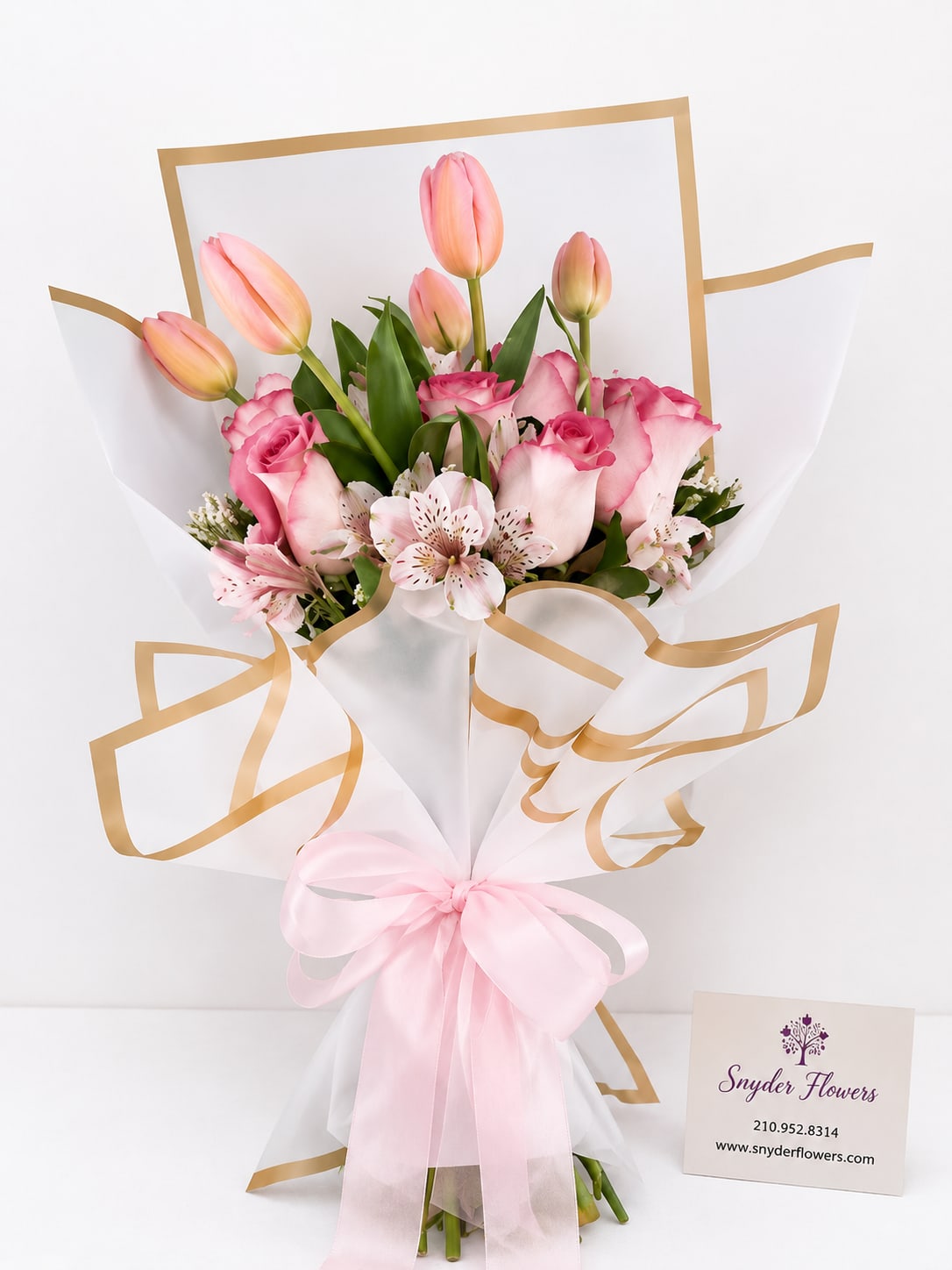 Pink tulips and roses in white wrap with a pink ribbon