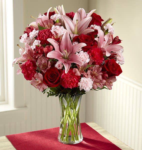 Forever Love Valentine's Day Bouquet by FTD - Picked fresh from the farm to bring the love and beauty of Valentine's Day straight to your special recipient's door, our Forever Love Valentine's Day Bouquet is that perfect picture gift you've been searching for. Hand gathered at select floral farms and bringing together an impressive array of blushing pink and red blooms, this unforgettable bouquet has been picked fresh for you to create a rush of romance in honor of this coming February 14th. Bouquet includes: pink Asiatic Lilies, red roses, pink Peruvian Lilies, red Peruvian Lilies, fuchsia carnations, pink mini carnations and lush greens. Available with or without a classic clear glass vase. BEST bouquet is approx. 20"H x 16"W.
