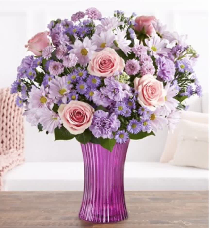 Pink roses and lavender daisies in a purple vase