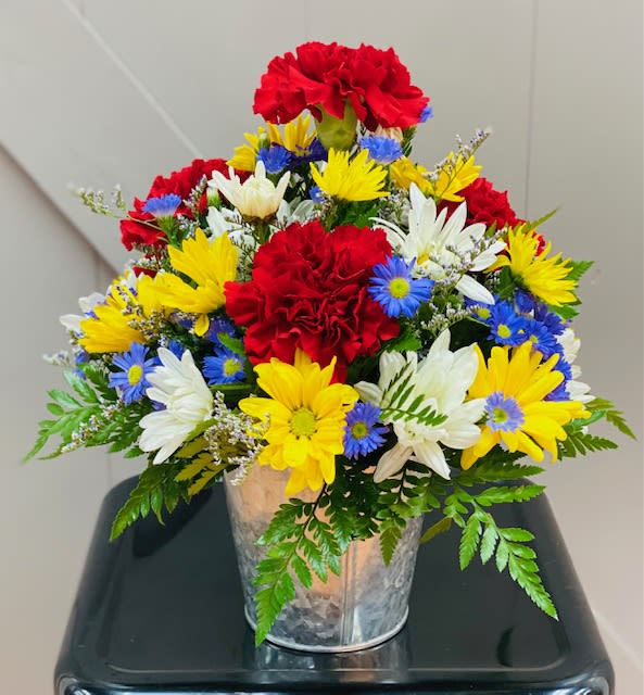 Bucket of flowers - This sweet tin pot holds the sweetest arrangement of flowers in the brightest colors.  