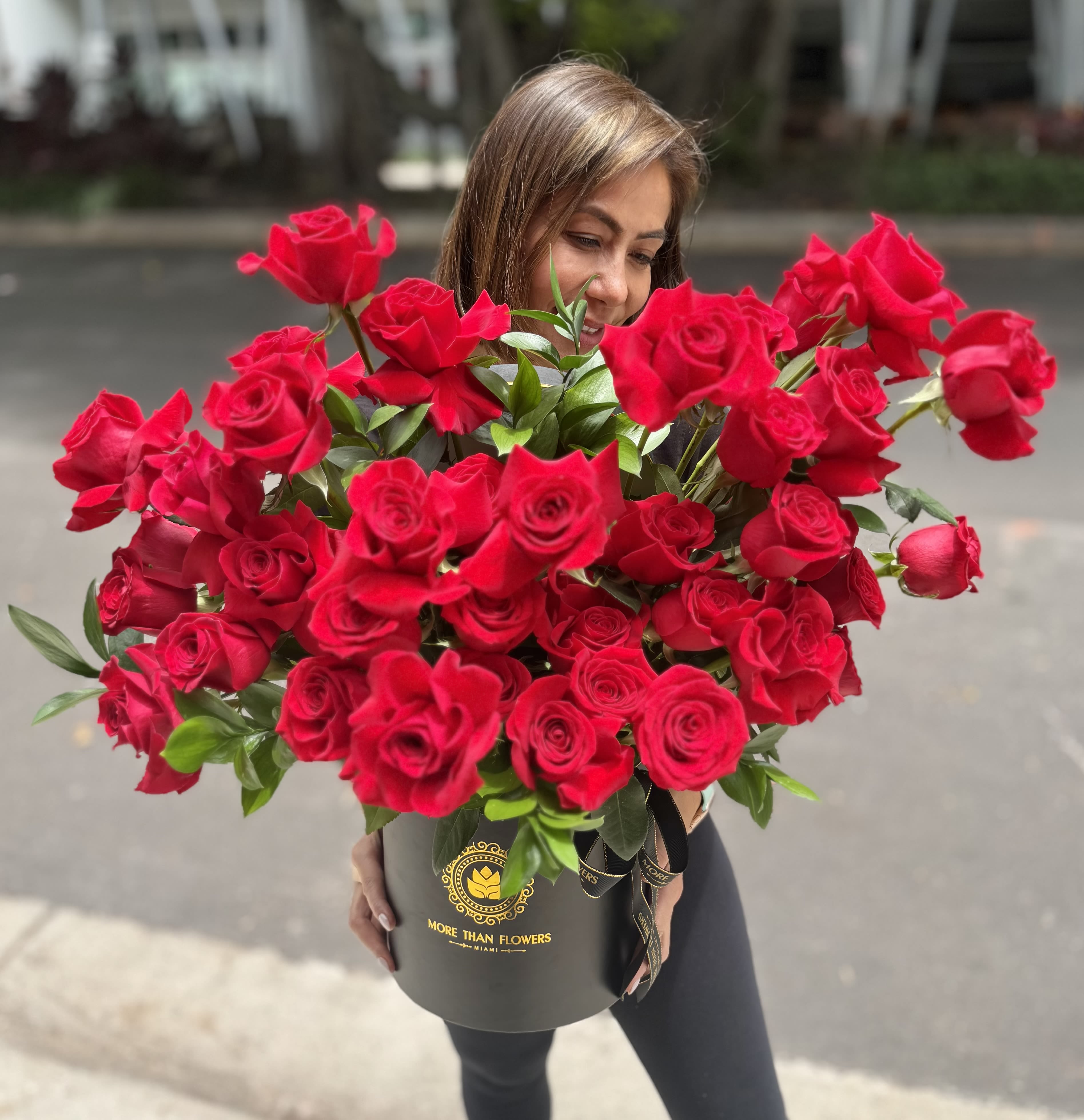 40 Reflexed Roses Hat Box -  Red - 40 reflexed vivid roses cluster arranged in our signature black hatbox with ribbon and glossy greens. Trendy Gift