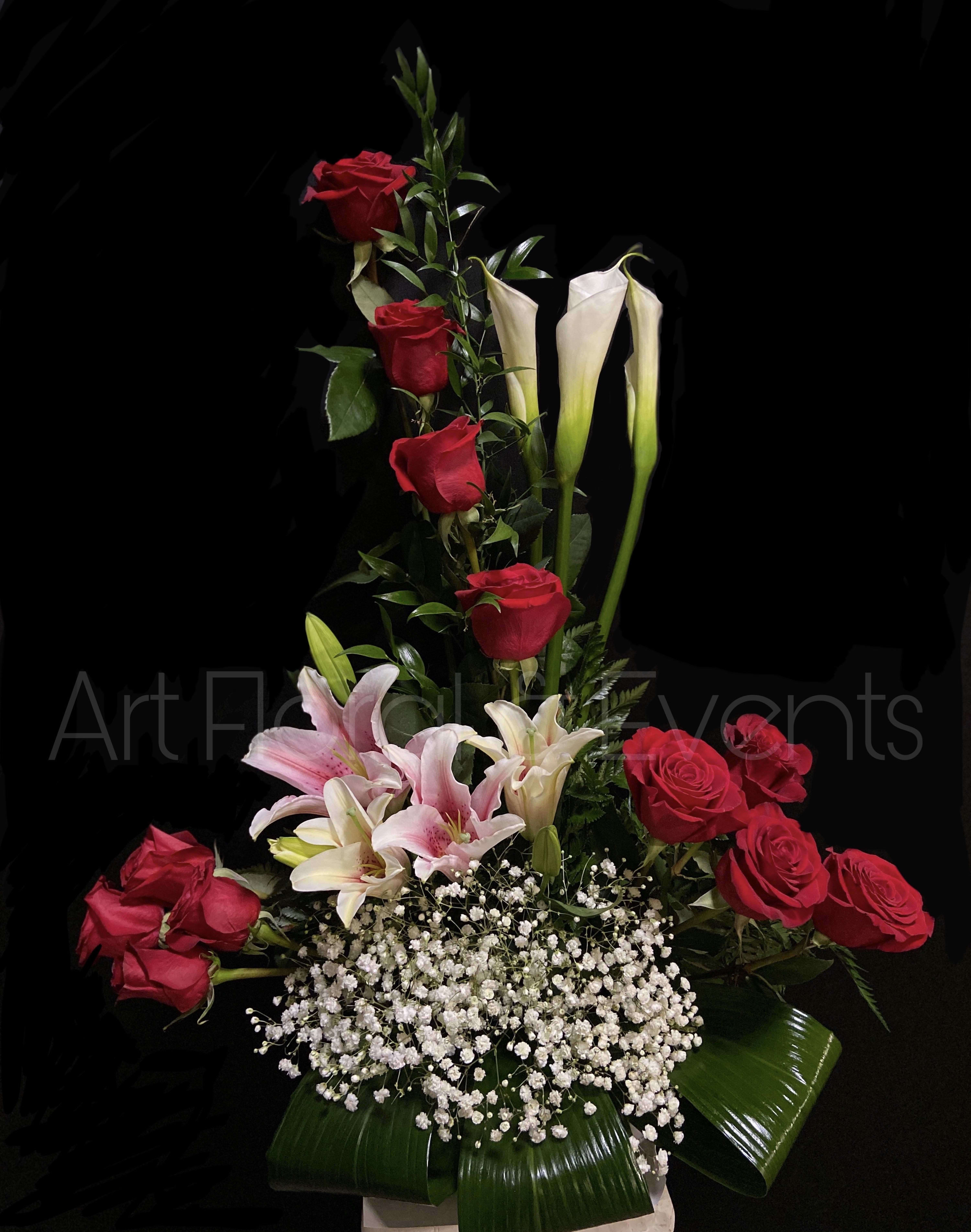 Tall arrangement of red roses, pink lilies, and white calla lilies