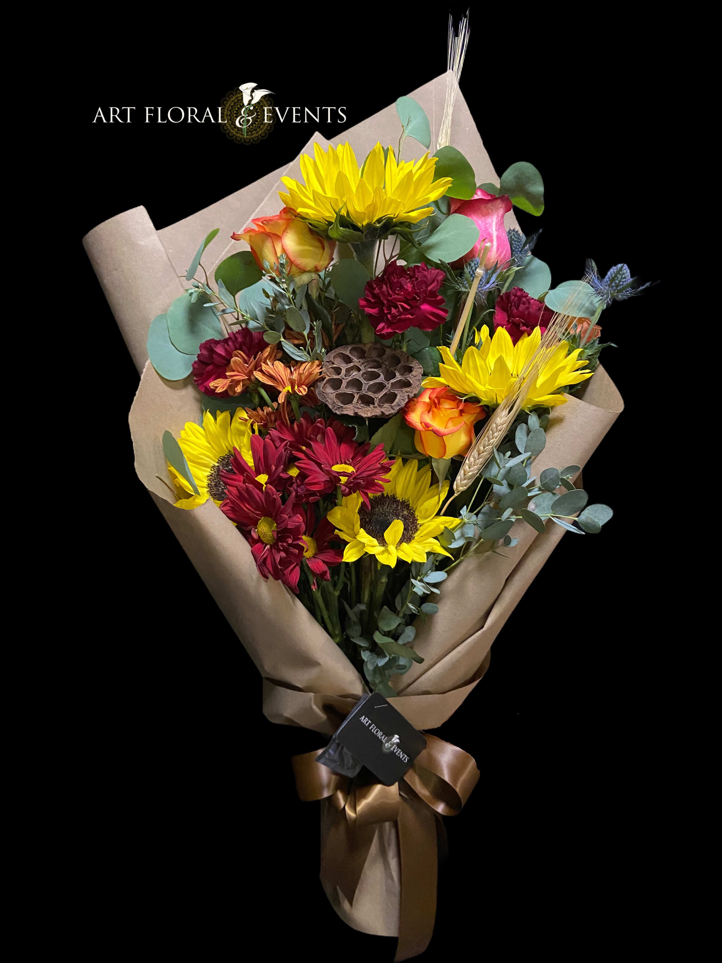 Bouquet of yellow sunflowers and red roses wrapped in brown paper