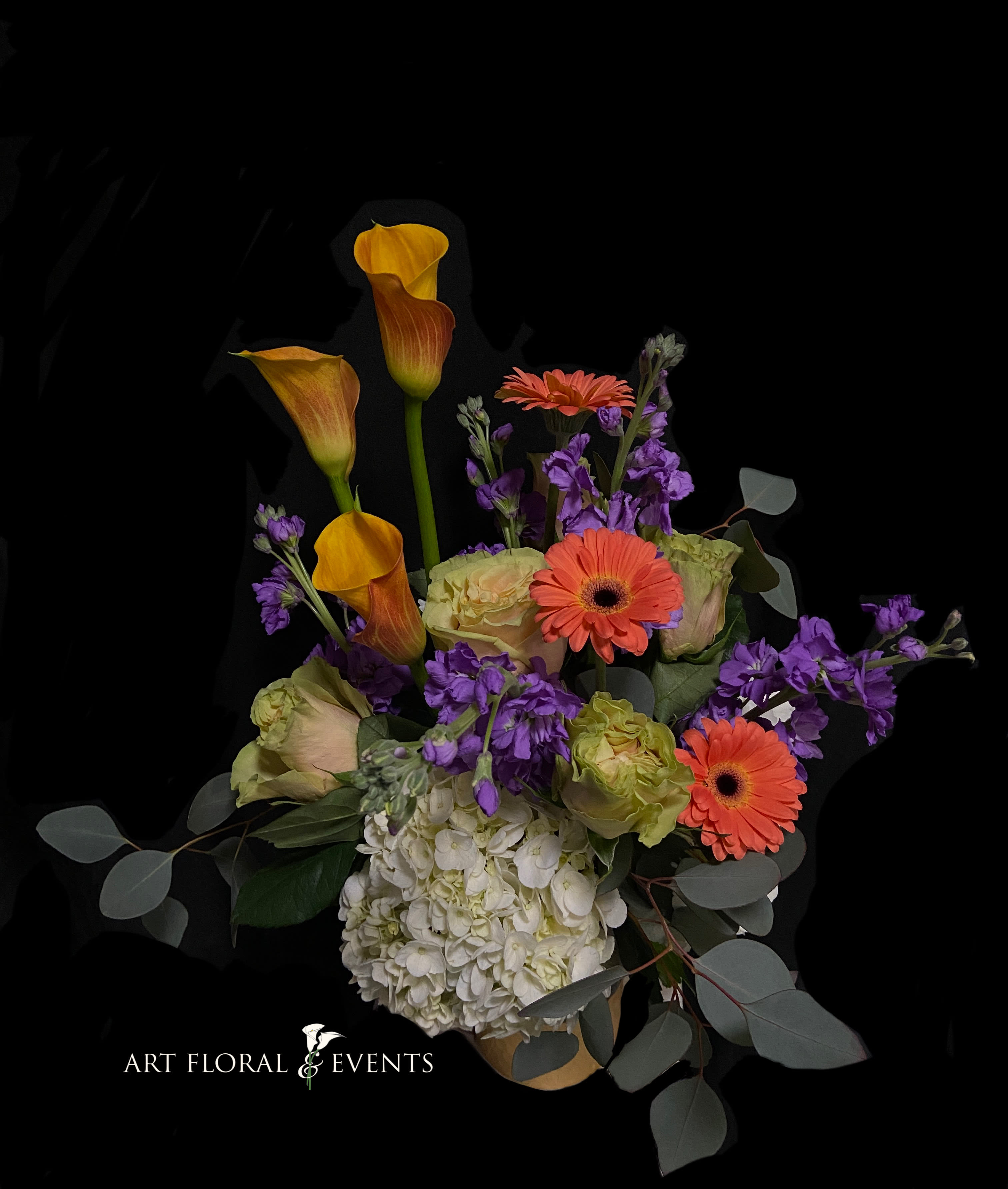 Bouquet with orange calla lilies, gerbera daisies, purple flowers, and white hydrangea