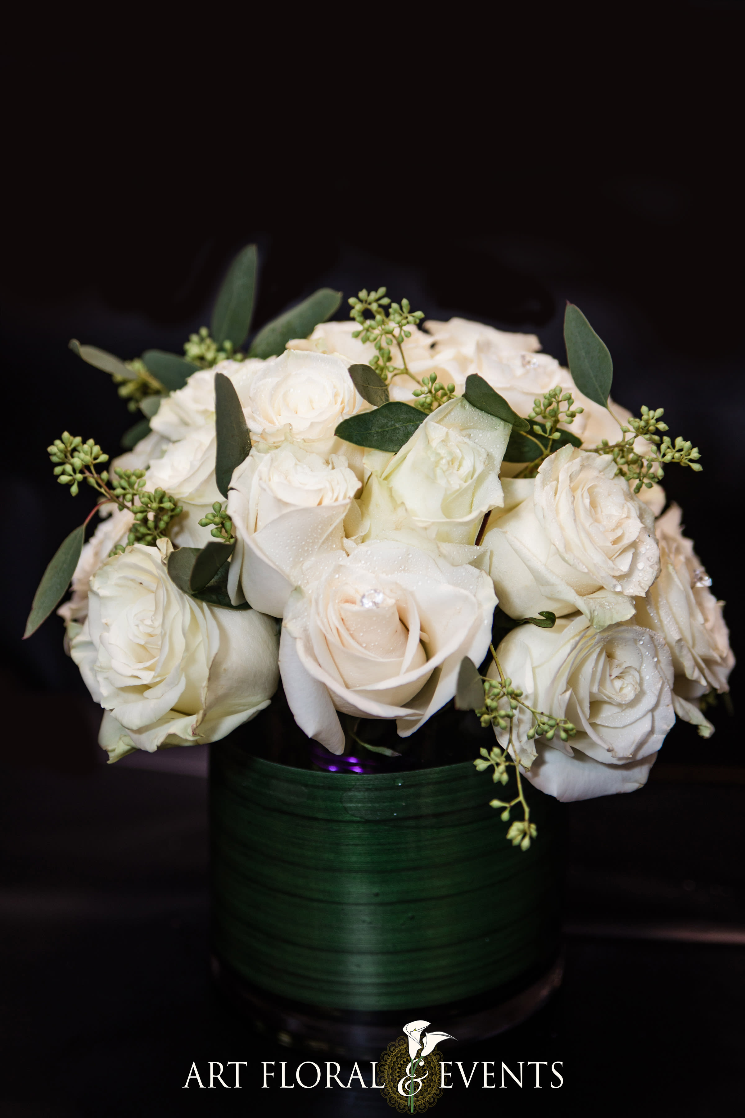 White rose bouquet in a dark green vase
