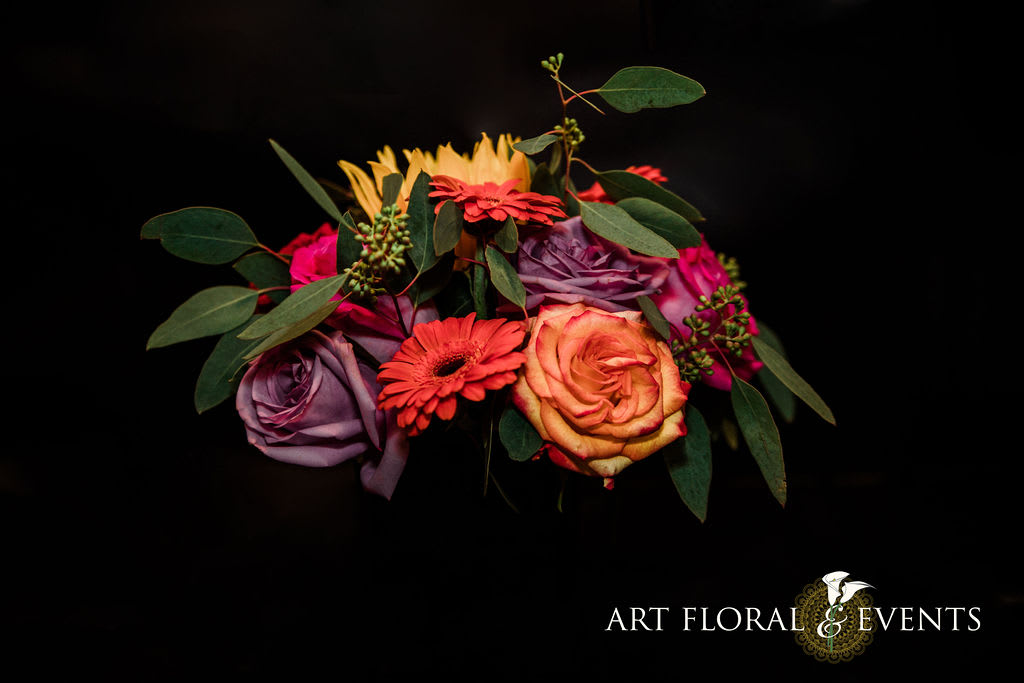 Colorful bouquet of roses and gerbera daisies with greenery
