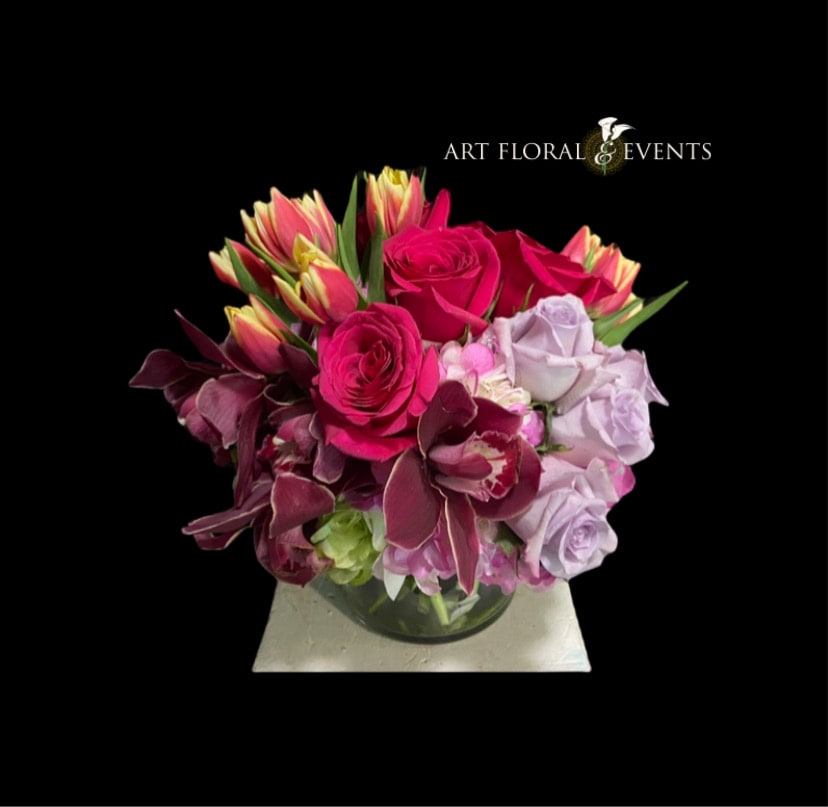 Pink and lavender rose arrangement in a glass vase