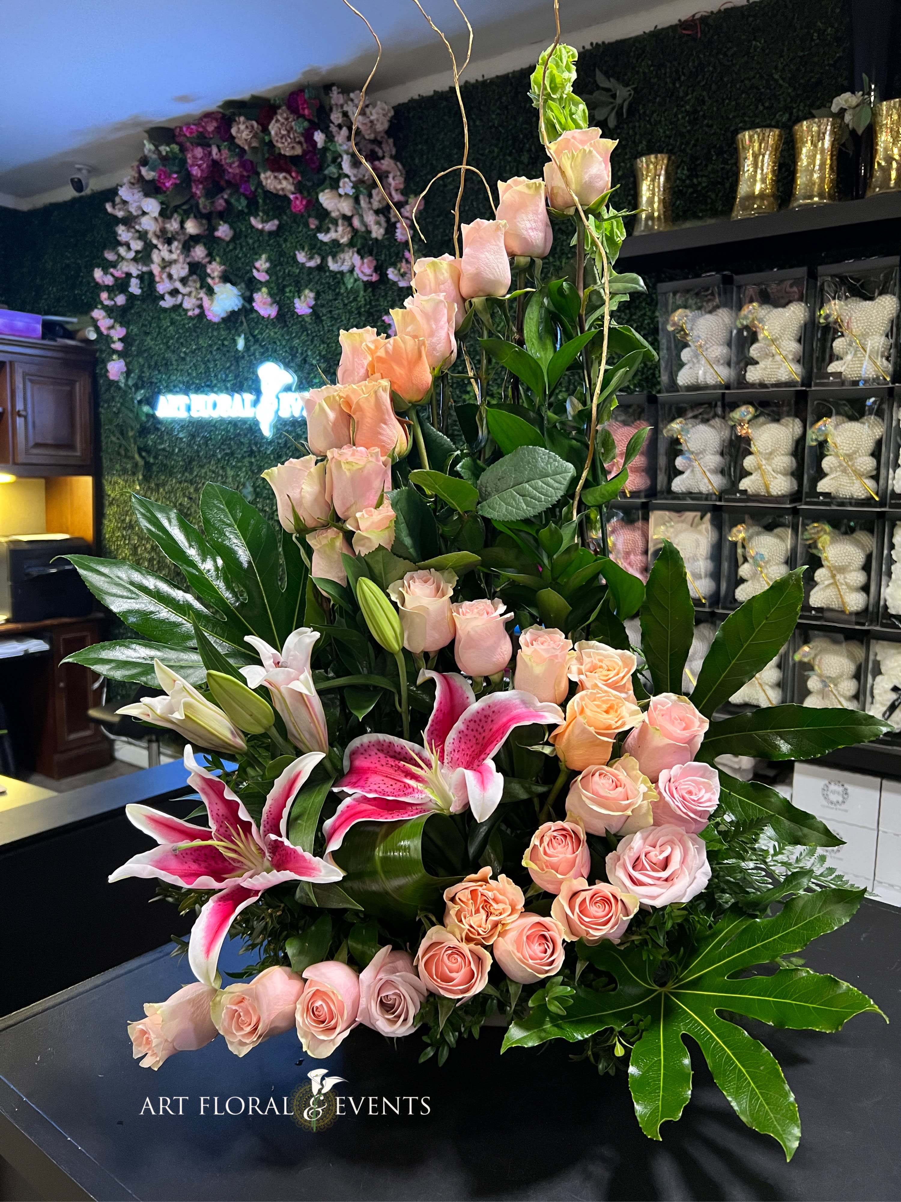 Tall floral arrangement with pink roses and pink lilies