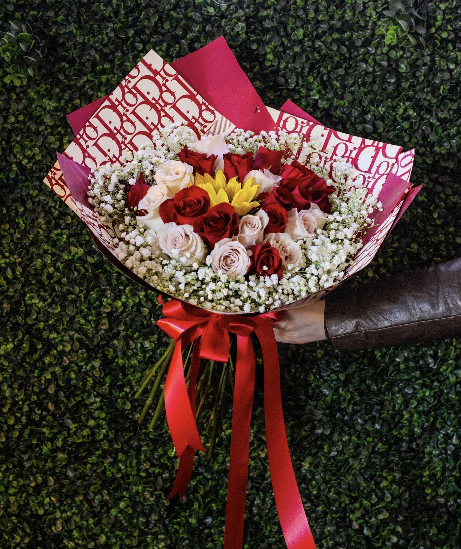 Bouquet of red and blush roses with yellow flowers and baby's breath