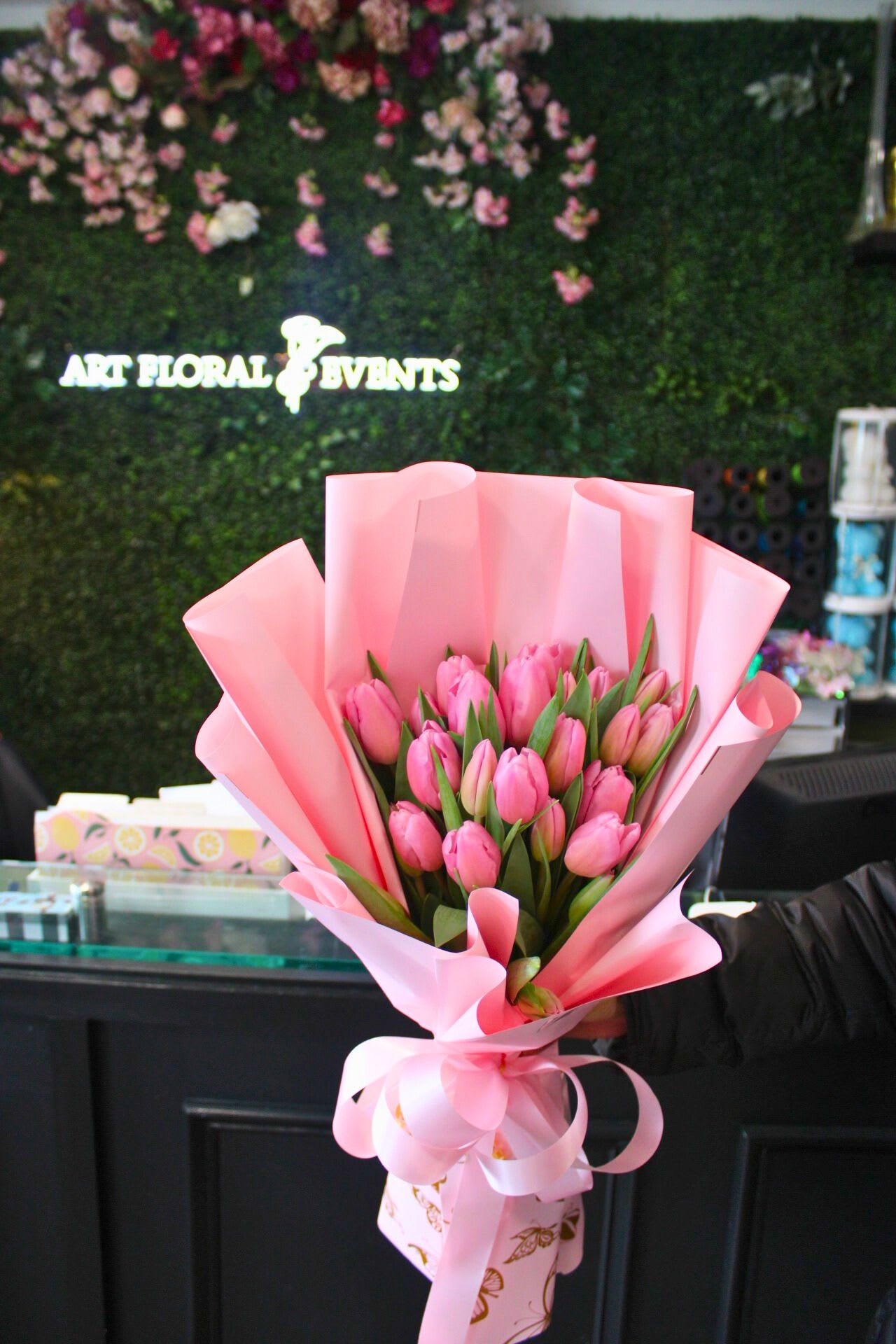 Pink tulip bouquet wrapped in pastel pink paper with a ribbon