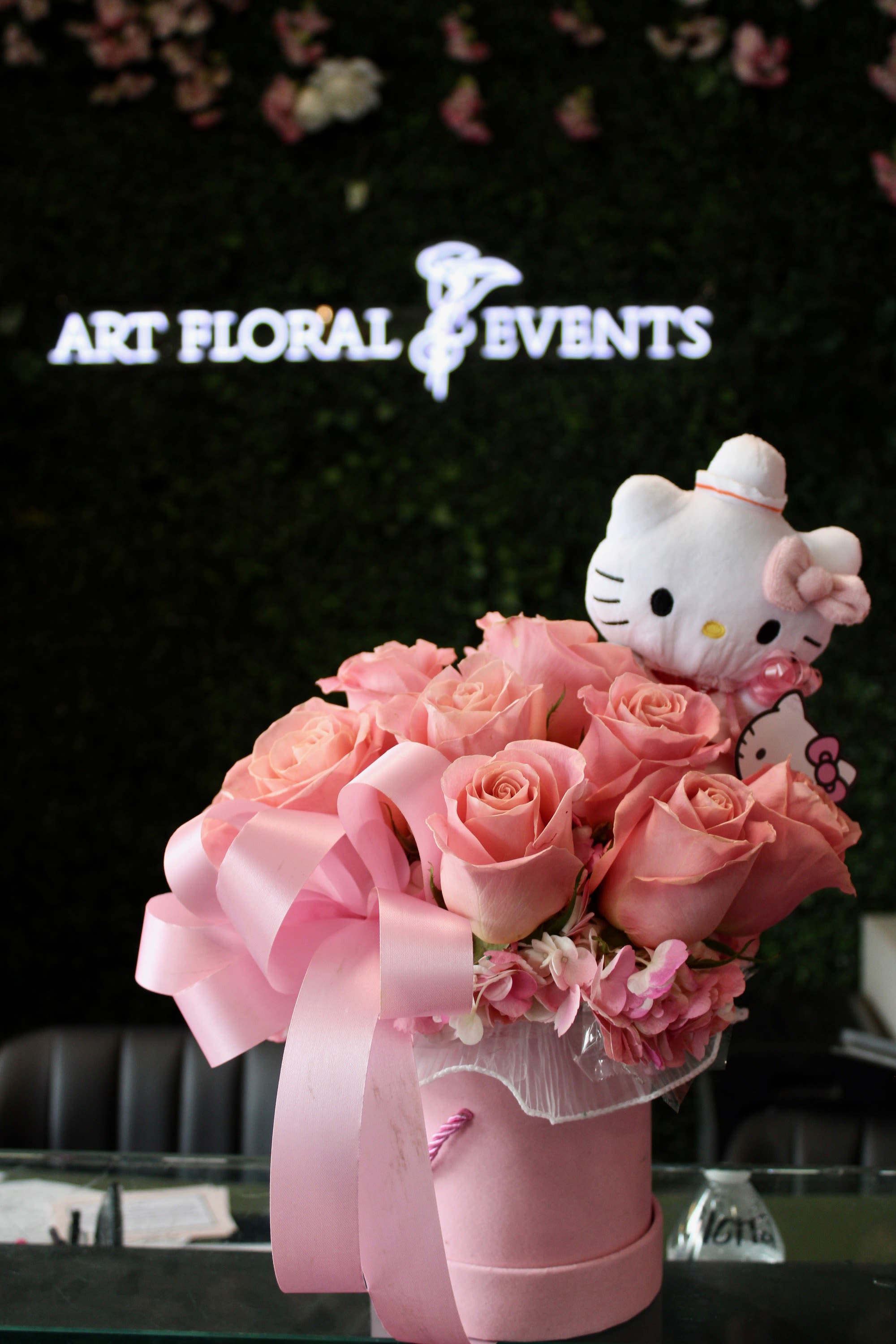 Pink rose bouquet in a pink hatbox with a Hello Kitty plush