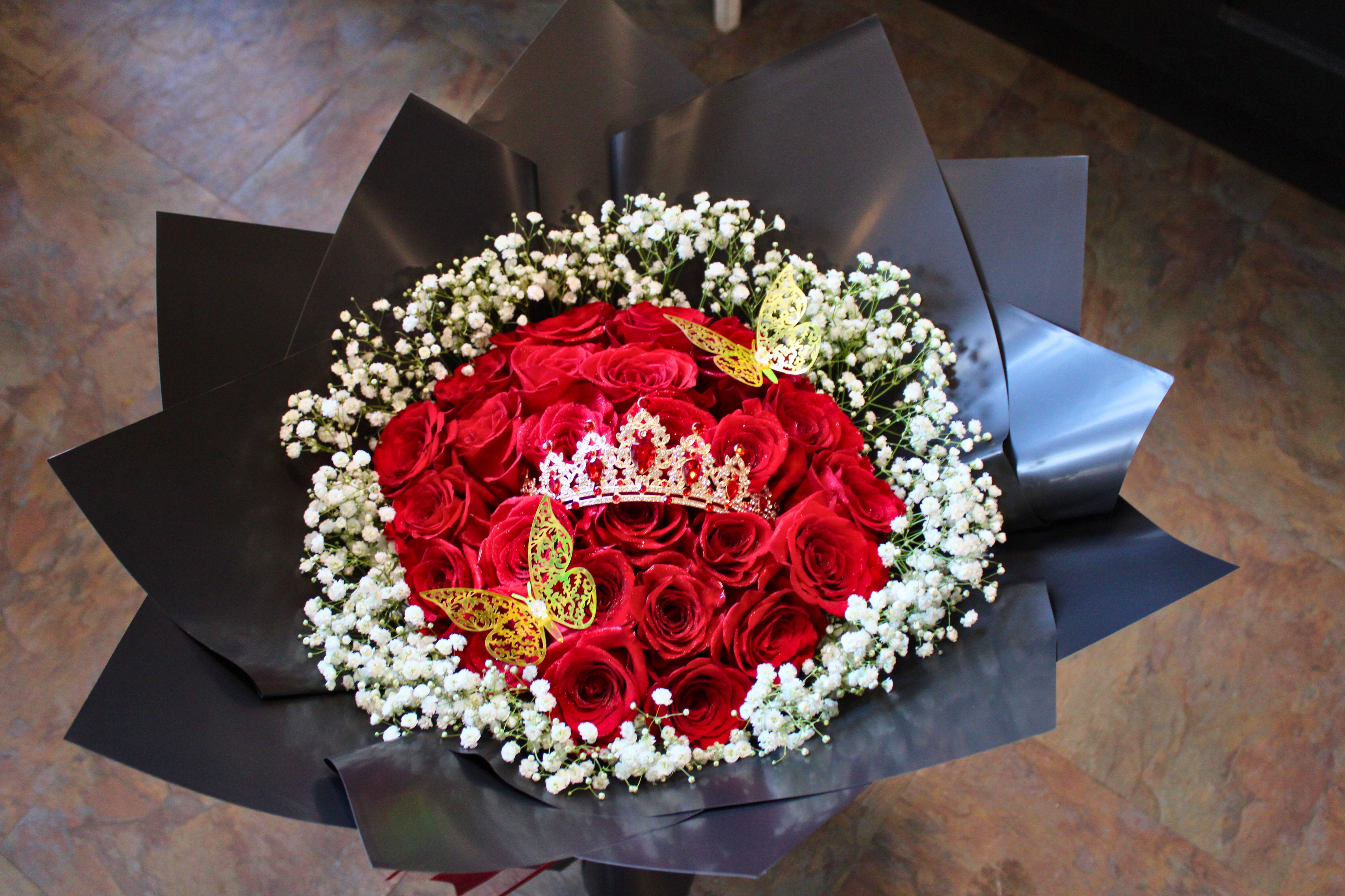 Red rose bouquet with white baby's breath and decorative butterflies