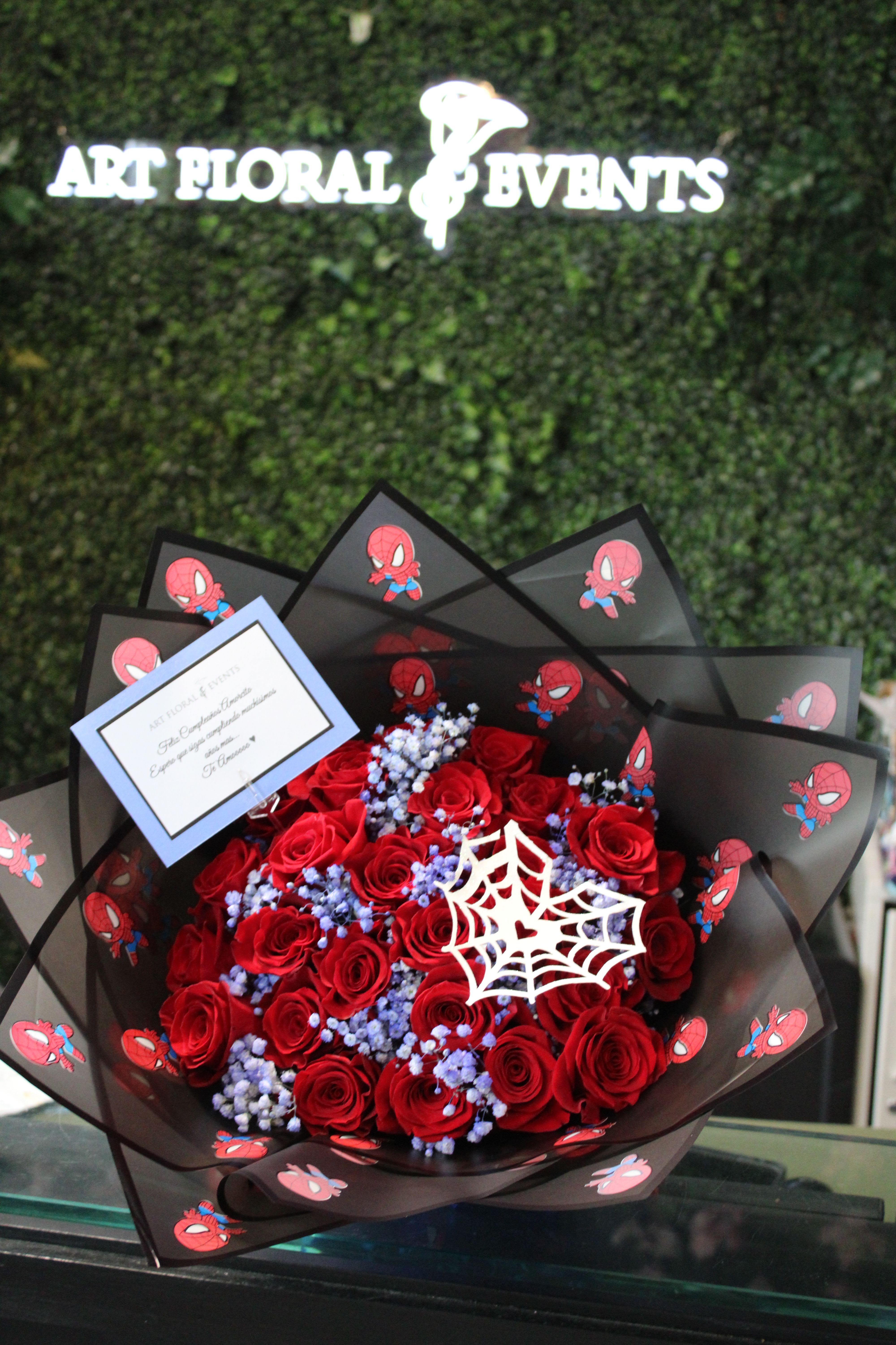 Bouquet of red roses with blue filler and Spider-Man wrapping