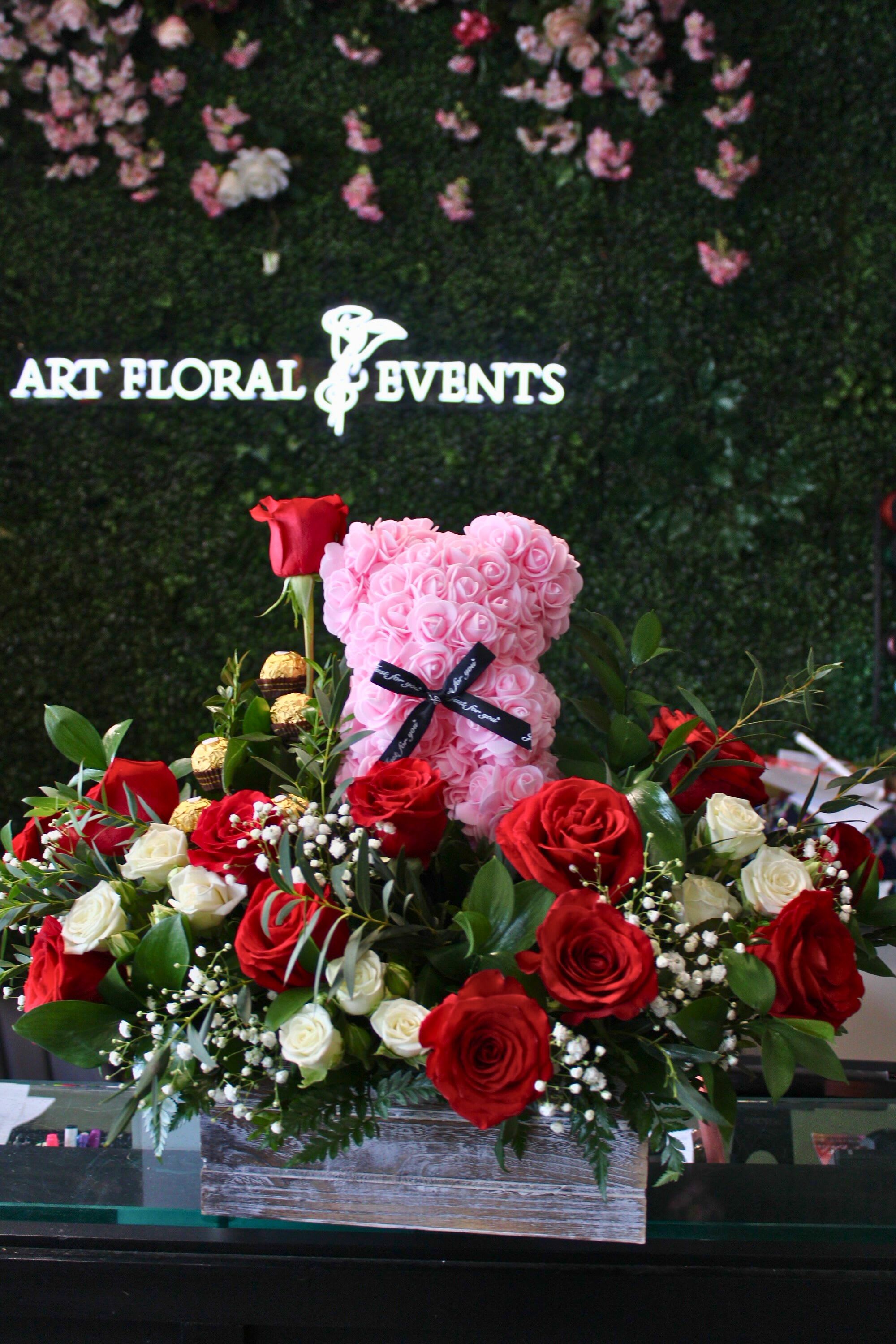Heart-shaped pink rose teddy with red and white roses in a wooden box
