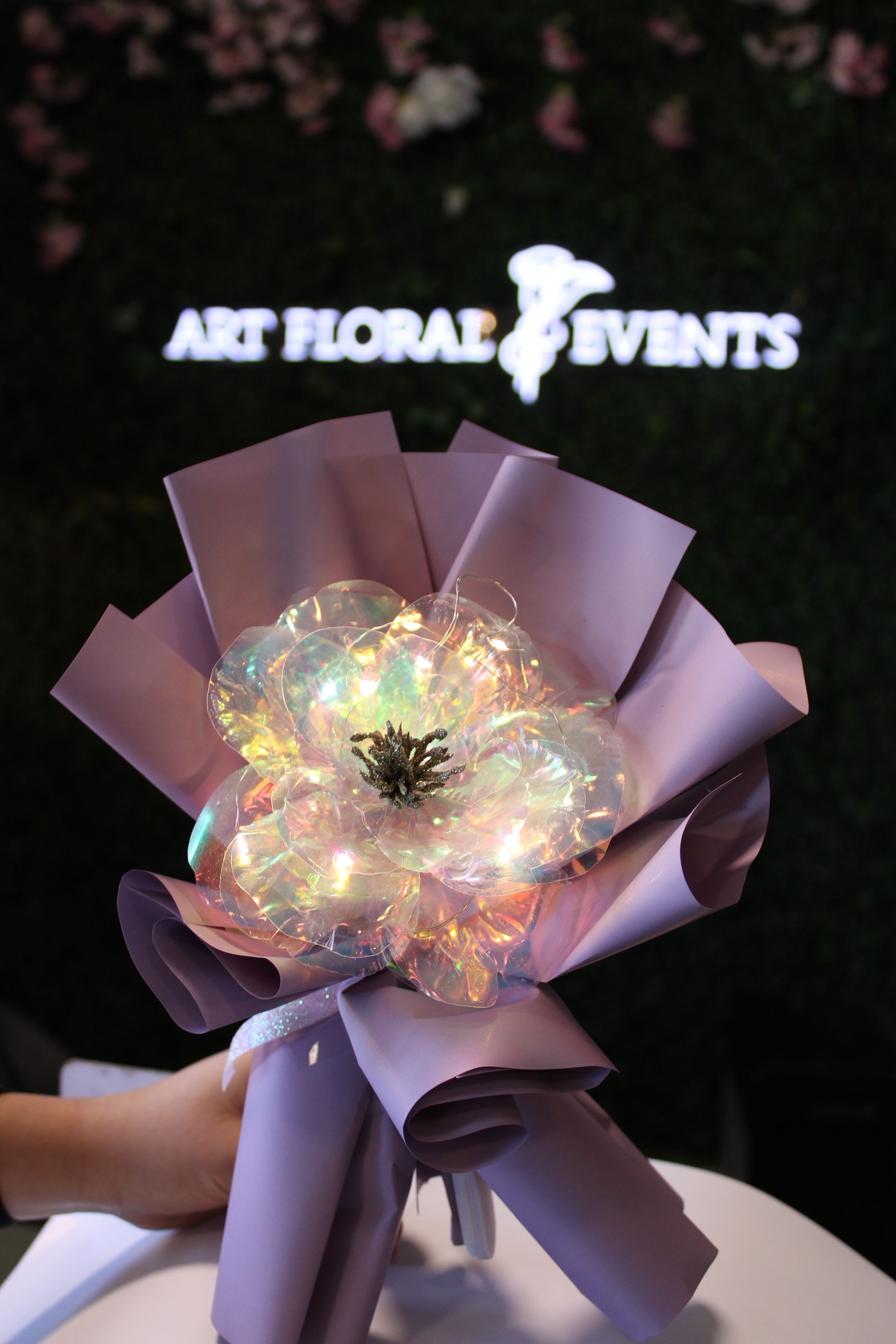 Iridescent flower wrapped in lavender paper