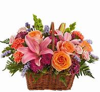 Basket of pink lilies, orange roses, and mixed flowers