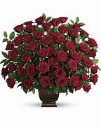 Large bouquet of red roses in a dark vase