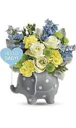 Flower arrangement in a gray elephant planter with a "Hello Baby!" sign