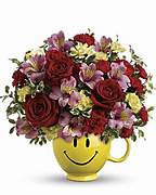 Mixed flower bouquet in a yellow smiley-face mug