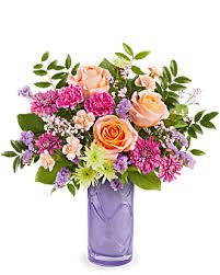 PRETTY  DAYDREAM BY TELEFLORA - mix of greens, pinks and peach in a lovely keepsake lavender vase