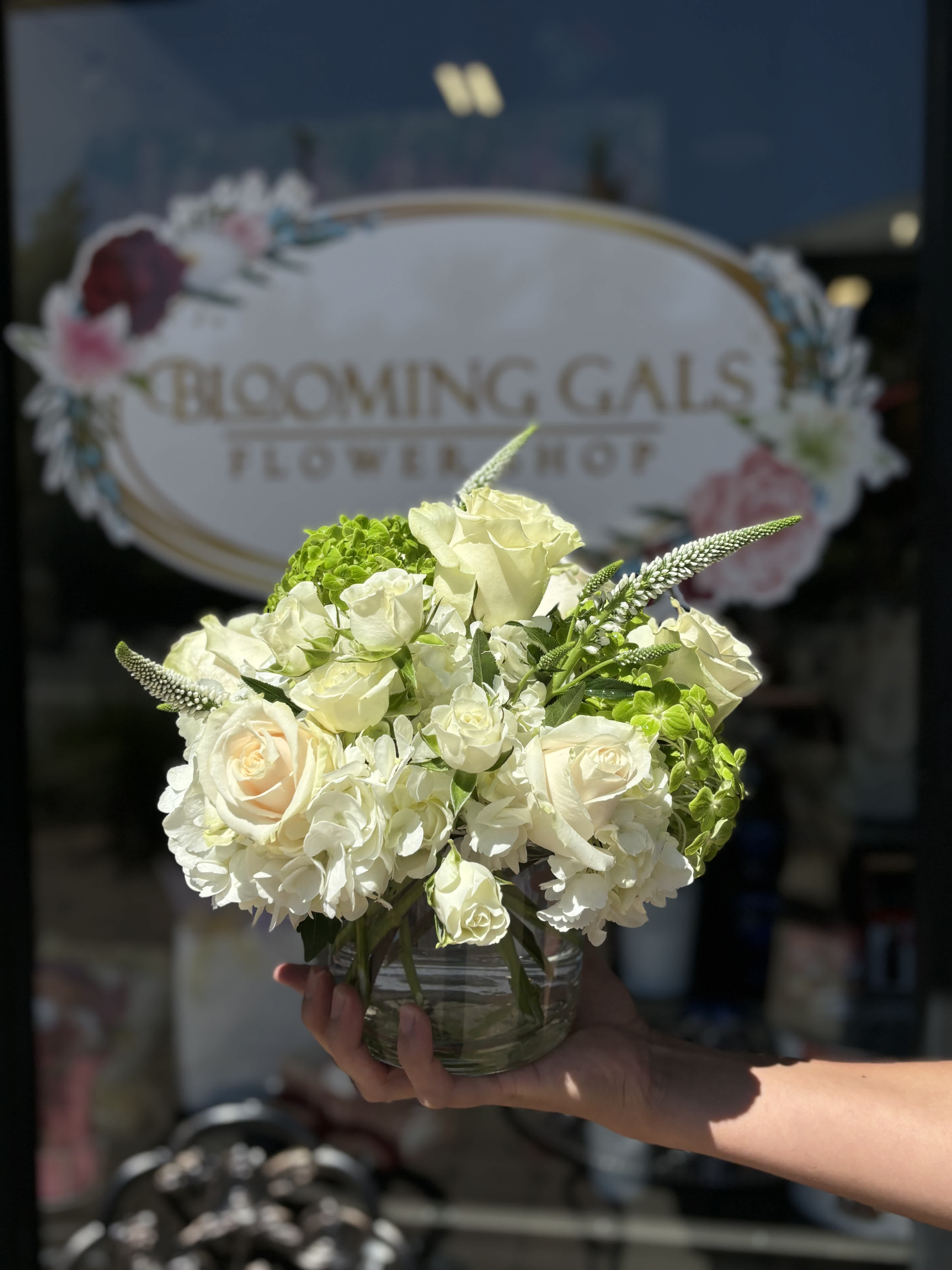 White rose and hydrangea bouquet in a clear glass vase