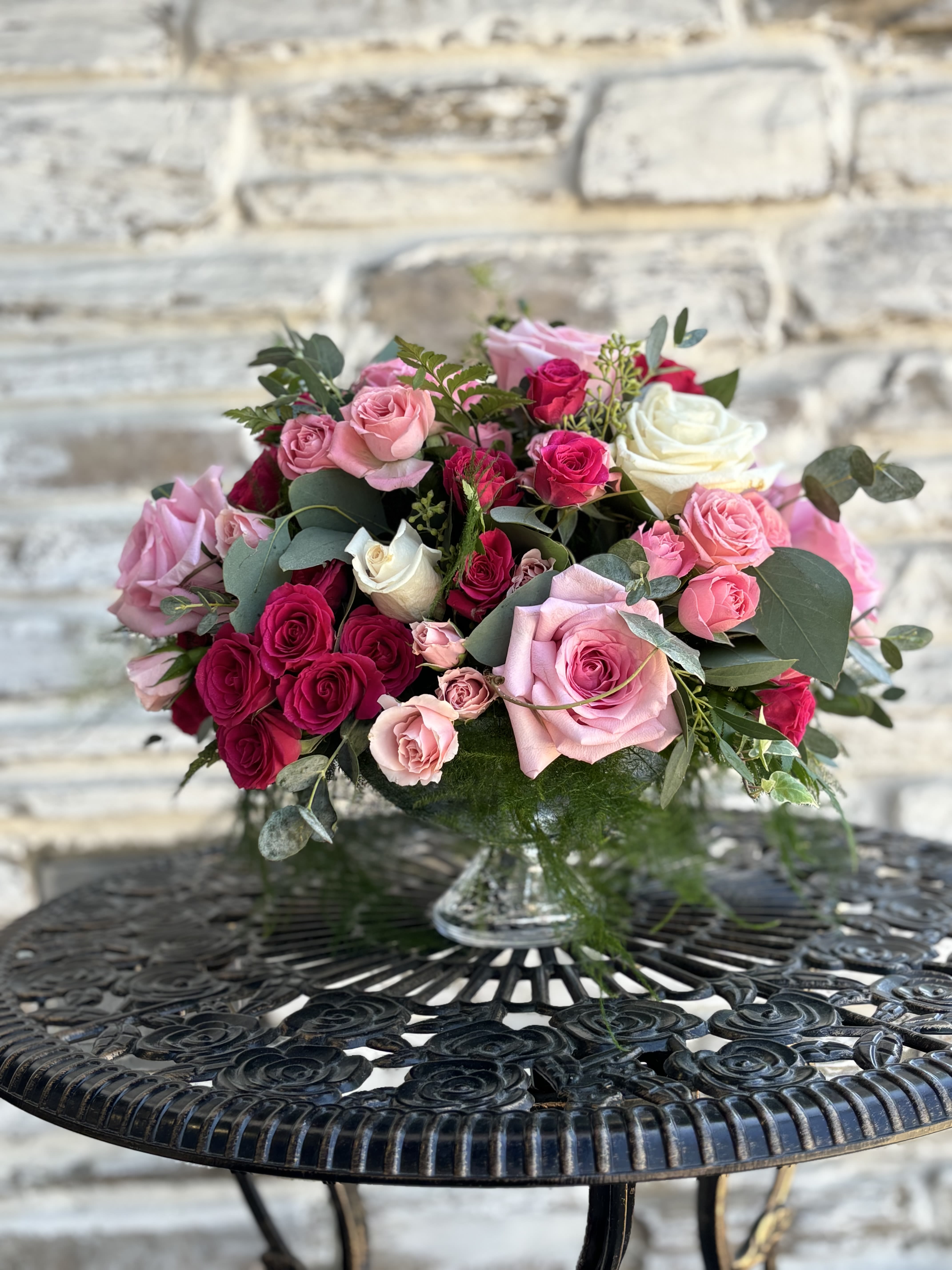 Pink and red rose bouquet in a clear glass vase