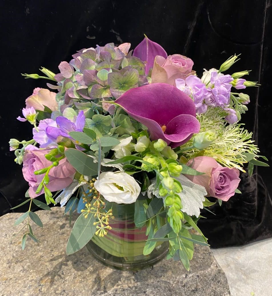 Bouquet of purple and pink flowers in a glass vase