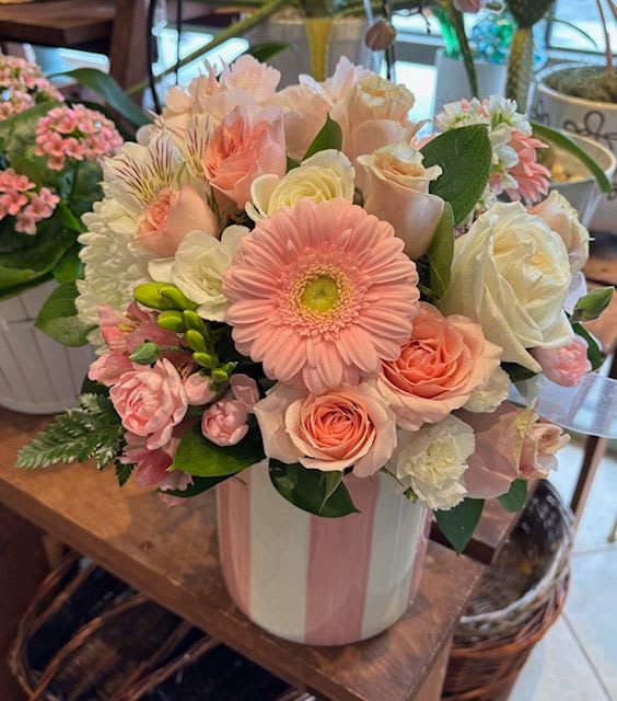 Pink and white mixed flower bouquet in a striped vase
