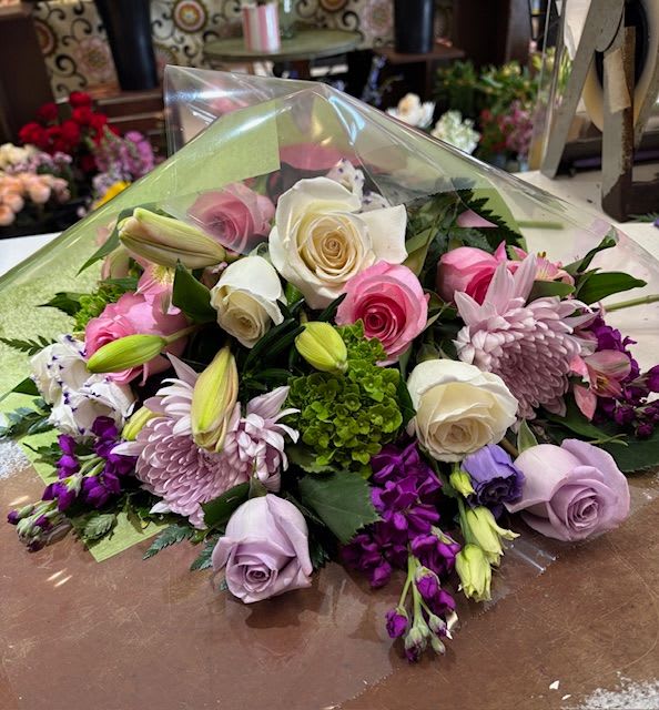 Premium Wrapped Bouquet - Most of us have a collection of glass vases stored away from previous floral gifts received.  Instead of creating waste, adding to your home's limited storage space and wasting money, why not let us wrap you a glorious bouquet?  You can order for either pick-up or delivery.  Feel free to give us direction with favorite colors and flowers or leave it up to us.  