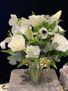 White floral bouquet in a clear glass vase