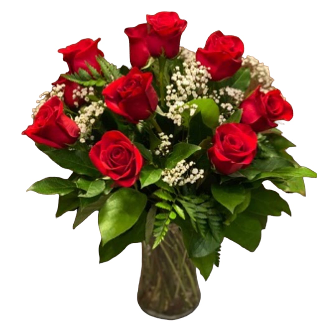 Bouquet of red roses with baby's breath in a glass vase