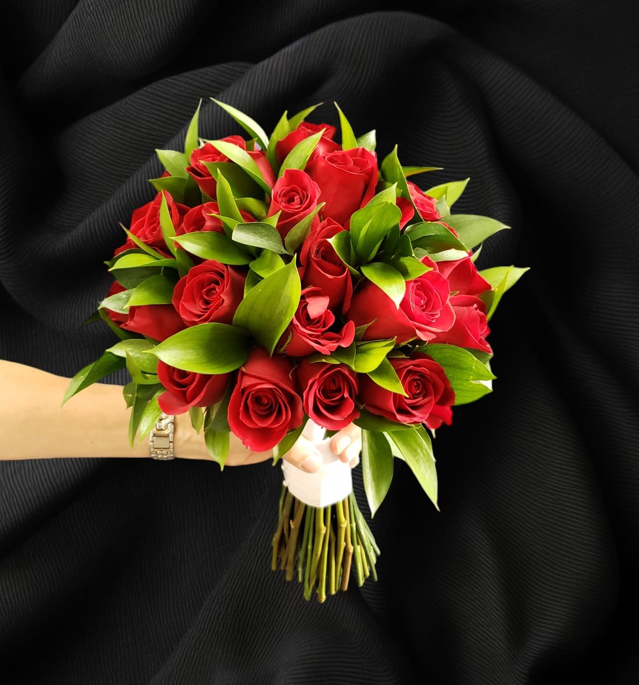 Bouquet of red roses with green foliage