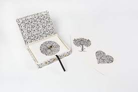 Decorative gift box with a patterned lid and matching heart and tree pieces