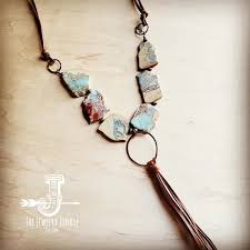 Beaded necklace with irregular stone-like pendants and a tassel