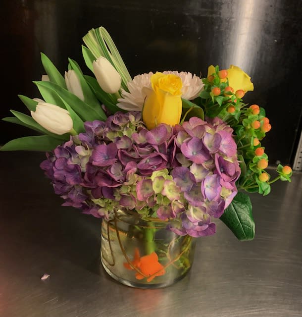 My Office Buddy - Cute FAUX goldfish swims at the bottom of this beautiful hydrangea design. Flowers featured: antique hydrangea. tulips, yellow roses, mums and hypericum.