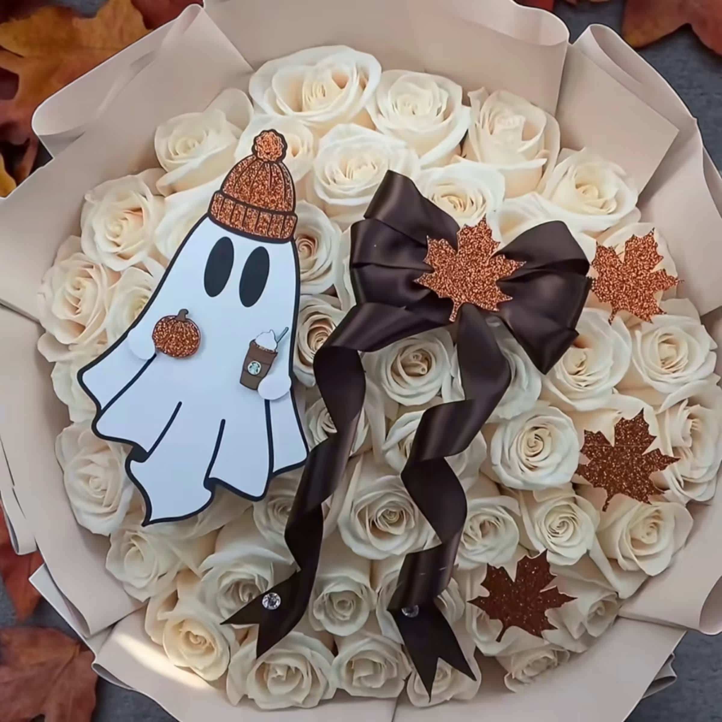 Bouquet of white roses with a ghost decoration and dark ribbon