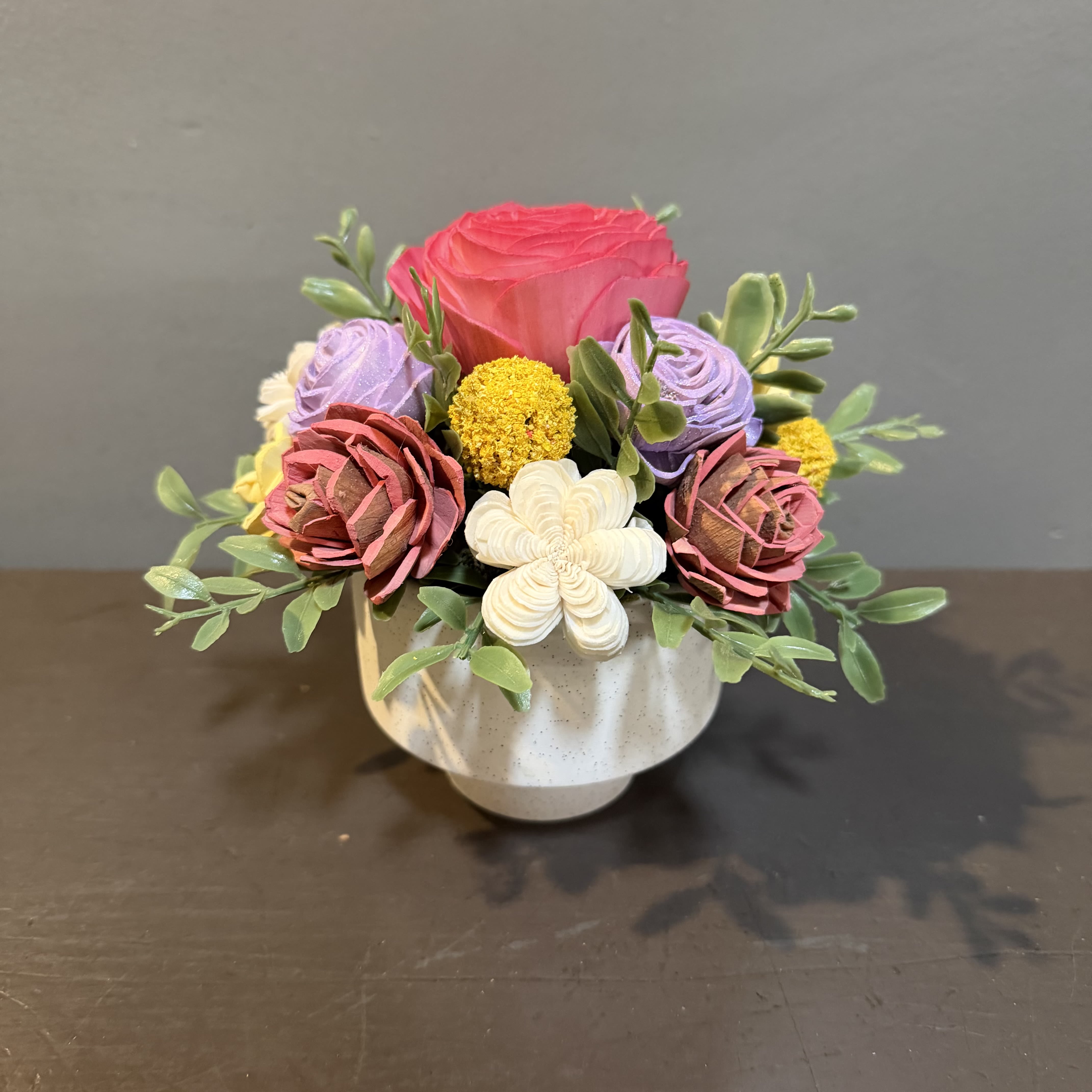 Sola Wooden Flower Centerpiece - Pink Rose Garden - Hand-crafted and hand-dyed by us, these flowers made of balsa wood are a wonderful everlasting floral arrangement - great for those with allergies! Can be used as a natural essential oil diffuser too!    Arrives in a keepsake ceramic vase and designed to look like our best selling Rose Garden. Approx. Dimensions: 7"Tx7"W 